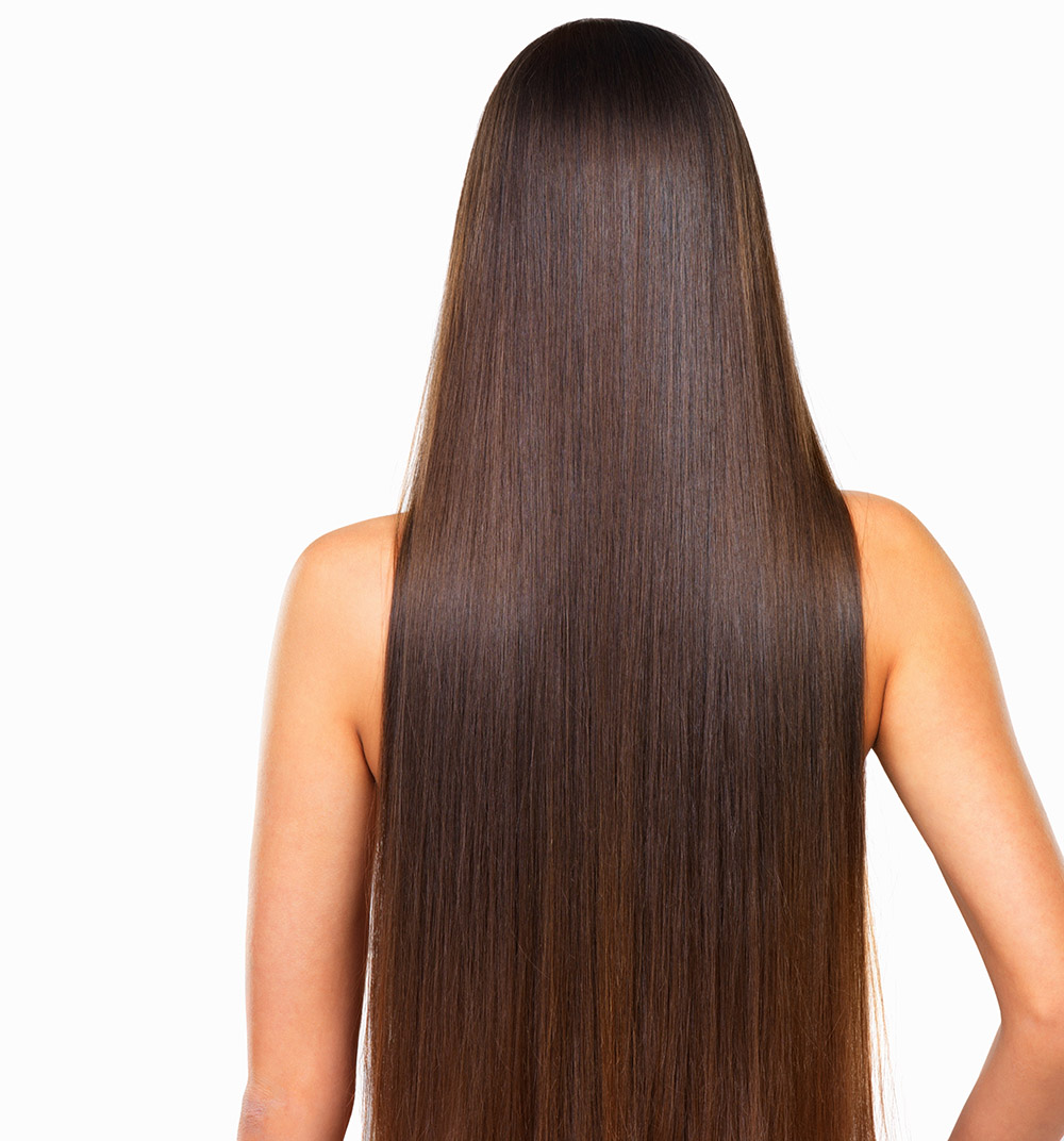 Rear view of woman with long hair over white background