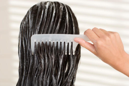 Woman combing her wet hair